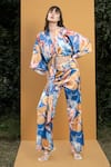 Buy_Mandira Wirk Resort_Blue Satin Hawaii Print V Neck Wrap Top And Bell Bottom Set_at_Aza_Fashions
