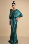 Buy_Kommal Sood_Green Lycra Stretch Net Embroidered Sequins Illusion Cape Sleeve Gown  _at_Aza_Fashions