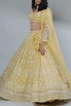 Shop_Astha Narang_Yellow Net, Crepe Leaf Neck Embroidered Lehenga Set _at_Aza_Fashions