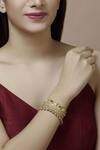 Buy Mira By Radhika Jain Gold Plated Metal Carved Bracelet at Aza Fashions Buy_Mira By Radhika Jain_Gold Plated Metal Carved Bracelet_at_Aza_Fashions