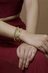 Mira By Radhika Jain Gold Plated Metal Carved Bracelet Online at Aza Fashions Mira By Radhika Jain_Gold Plated Metal Carved Bracelet_Online_at_Aza_Fashions