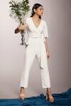 Shop_Couché By Anandini_White Punto Plain V Neck Front Tie-up Jumpsuit _at_Aza_Fashions