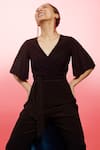 Shop Couché By Anandini Black Punto Plain V Neck Front Tie-up Jumpsuit at Aza Fashions Shop_Couché By Anandini_Black Punto Plain V Neck Front Tie-up Jumpsuit _at_Aza_Fashions