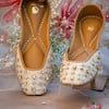Buy_Shilpsutra_Beige Embroidered Kanakam Jewel Encrusted Juttis_at_Aza_Fashions