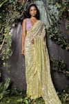 Kashmiraa_Yellow Net Hand Embroidered Cutdana Blunt V Neck Saree With Blouse _at_Aza_Fashions