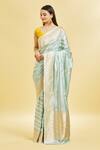 Mint N Oranges_Blue Silk Zari Round Neck Floral Pattern Saree With Blouse Piece_at_Aza_Fashions