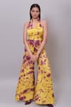 Buy_Nayantaara_Yellow Bamberg Satin Tie Dye Abstract Pattern Halter Collar Flared Jumpsuit _at_Aza_Fashions