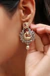 Buy_Noor_Gold Plated Embellished Peacock Carved Dual Tone Earrings _at_Aza_Fashions