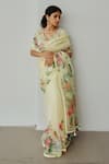 Buy_WABI SABI BY ANSHUM-RITESH_Yellow Organza Hand Painted Floral V Neck Valley Of Flowers Saree With Blouse _at_Aza_Fashions