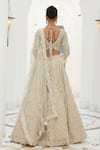 Shop_Nitika Gujral_Ivory Net Embroidery Tonal Silver Beads V Neck Lily Bloom Bridal Lehenga Set _at_Aza_Fashions