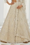 Nitika Gujral_Ivory Net Embroidery Tonal Silver Beads V Neck Lily Bloom Bridal Lehenga Set _Online_at_Aza_Fashions