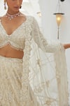 Shop_Nitika Gujral_Ivory Net Embroidery Tonal Silver Beads V Neck Lily Bloom Bridal Lehenga Set _Online_at_Aza_Fashions