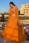 Buy_Kiran Kalsi_Orange Net Embroidery Sweetheart Neck Floral Hand Lehenga Set _at_Aza_Fashions