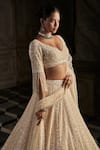 Buy_Seema Gujral_Cream Net Embroidery Crystal Plunging Neck Pearl Bridal Lehenga Set _Online_at_Aza_Fashions
