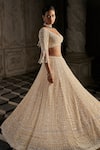 Shop_Seema Gujral_Cream Net Embroidery Crystal Plunging Neck Pearl Bridal Lehenga Set _Online_at_Aza_Fashions