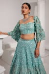 SWATI WADHWANI COUTURE_Blue Net Embroidered Sequin Sweetheart Lehenga With Floral Applique Work Blouse _at_Aza_Fashions