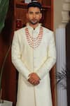 Shop_YAJY by Aditya Jain_Ivory Silk Embroidery Thread Paisley And Floral Sherwani Set 