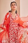 Shop_MANDIRA WIRK - Indian_Red Satin Printed Floral Cowl Neck Jumpsuit With Ruffle Cape _Online_at_Aza_Fashions