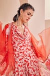 Shop_Mandira Wirk_Red Satin Printed Floral Cowl Neck Jumpsuit With Ruffle Cape _at_Aza_Fashions