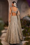 Shop_Charu and Vasundhara_Silver Net Hand Embroidered Stone Leaf Neck Lily Bead Bridal Lehenga Set_at_Aza_Fashions