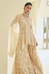 Shop_Seema Gujral_Beige Net Embroidered Sequin Paisley High-low Jacket Sharara Set _at_Aza_Fashions
