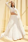 Buy_Istya_Ivory Net Embellished Sequins Tear Drop V Neck Rosette Bloom Bridal Lehenga Set _at_Aza_Fashions