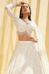 Buy_Istya_Ivory Net Embellished Sequins Tear Drop V Neck Rosette Bloom Bridal Lehenga Set _Online_at_Aza_Fashions