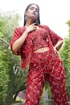 Shop_Istya_Red Net Embroidered Sequins Bustier V Neck Tassel Pant Set With Crop Jacket _at_Aza_Fashions