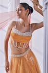 Shop_Mandira Wirk_Peach Net Embroidered Pearl Sweetheart Ombre Embellished Lehenga Set_at_Aza_Fashions