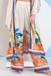 Mandira Wirk_Ivory Satin Printed Vivid Floral Cape Open Flared Pant Set_Online_at_Aza_Fashions