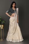 Nidhi Kejriwal_Off White Velvet Hand Embroidered Border Pre-draped Lehenga Saree With Blouse _at_Aza_Fashions