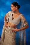 Charu and Vasundhara_Gold Skirt Net Embroidered Mother Of Pearl Leaf Valaria Cape Lehenga Set_Online_at_Aza_Fashions
