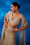 Charu and Vasundhara_Gold Skirt Net Embroidered Mother Of Pearl Leaf Valaria Cape Lehenga Set _Online_at_Aza_Fashions