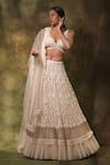 Buy_Archana Kochhar_Ivory Net Embroidered Pearls Deep V Neck Floral And Lehenga Set _at_Aza_Fashions