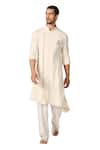 S&N by Shantnu Nikhil_Off White Brushed Suiting Crest Embroidered Asymmetric Kurta_Online_at_Aza_Fashions