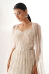 Chaashni by Maansi and Ketan_White Net Embellished Sequins Cape Open Stripe Cutdana With Cut-out Gown_at_Aza_Fashions