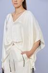 DILNAZ_Cream Blended Satin Embellished Feather V-neck Solid Asymmetric Short Kaftan _Online_at_Aza_Fashions