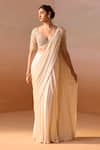 Buy_Nitika Gujral_Ivory Net Embroidery Dori Pearl Tassel Embellished Pre-draped Saree With Blouse _at_Aza_Fashions