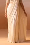 Nitika Gujral_Ivory Net Embroidery Dori Pearl Tassel Embellished Pre-draped Saree With Blouse _Online_at_Aza_Fashions