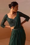 Nitika Gujral_Green Satin, Net Beads, Smocking Tassel Embellished Pre-draped Saree With Blouse _at_Aza_Fashions