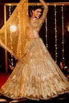 Shop_Isa By Dolly Wahal_Gold Net Hand Embroidery Sequin V-neck Icarus Lehenga Set _at_Aza_Fashions