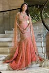 Shop_Isa By Dolly Wahal_Peach Net Hand Embroidery Sequins Sweetheart Coral Fishcut Lehenga Set _at_Aza_Fashions