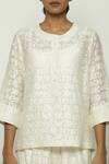 Abraham & Thakore_Ivory Chanderi Round Calligraphy Cutwork Pattern Top _at_Aza_Fashions