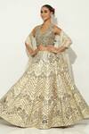 Buy_Vandana Sethi_Gold Shimmer Raw Silk Embellished Mirrorwork Halter Neck Floral Lehenga Set _at_Aza_Fashions