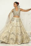 Vandana Sethi_Gold Shimmer Raw Silk Embellished Mirrorwork Halter Neck Floral Lehenga Set _at_Aza_Fashions