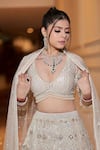 Shop_Sidhaarth & Disha_Ivory Net Embroidery Sequin V Neck Chevron Bridal Lehenga Set _at_Aza_Fashions