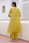 Shop_Vaayu_Yellow Muslin Cotton Embroidered Floral Applique Round Kurta And Pant Set _at_Aza_Fashions