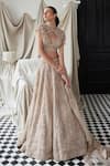 Buy_Istya_Beige Net Embroidery Sequins Blouse Plunging Floral Bridal Lehenga And Cape Set _at_Aza_Fashions