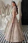 Shop_Istya_Beige Net Embroidery Sequins Blouse Plunging Floral Bridal Lehenga And Cape Set _at_Aza_Fashions