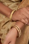 Buy_Smars Jewelry_Gold Plated Pearl Embellished Scalloped Bangles-Set of 4 _at_Aza_Fashions